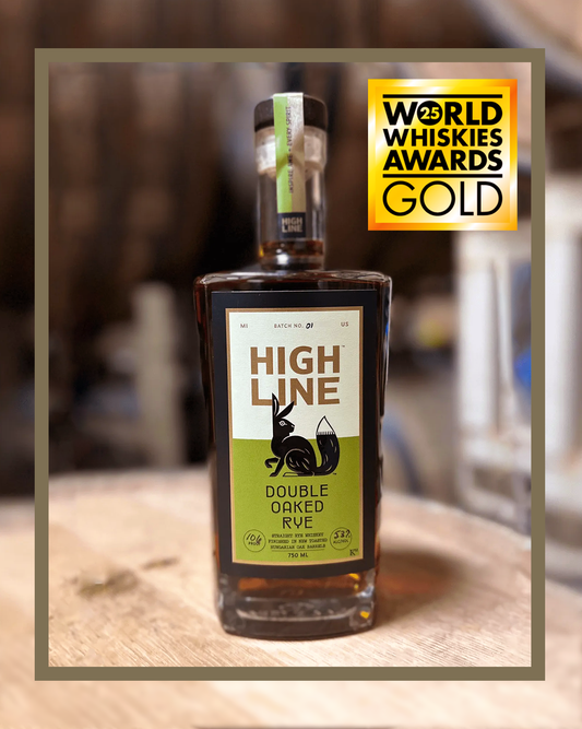 Bottle of High Line Double Oaked Rye on a wooden surface with a blurred background